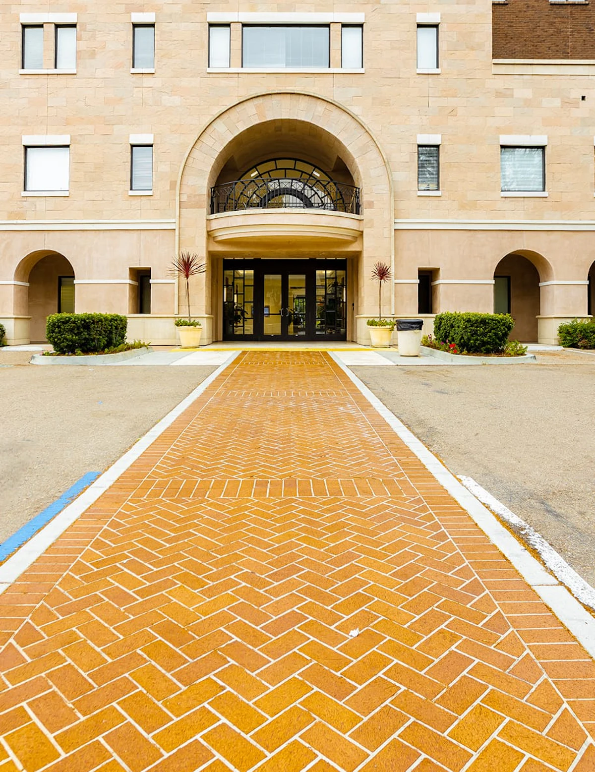 Brick walkway leading to the entrance of a surgical building