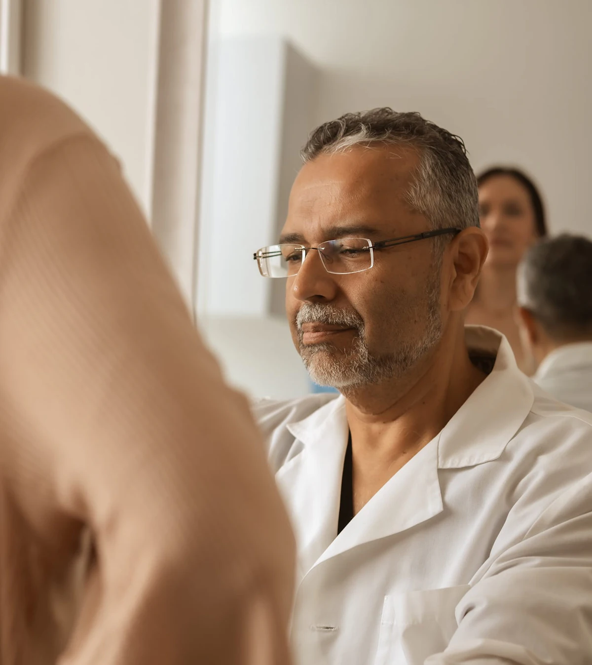 Plastic surgeon talking with a patient in a bright consultation room